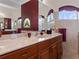 Double vanity bathroom with stained glass window at 13217 Thoroughbred Dr, Dade City, FL 33525