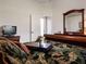 Main bedroom with a comfortable bed and access to the bathroom at 13217 Thoroughbred Dr, Dade City, FL 33525