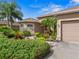 Attractive home exterior with landscaping and a two-car garage at 13217 Thoroughbred Dr, Dade City, FL 33525