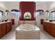 Primary bathroom with a large soaking tub and double vanities at 13217 Thoroughbred Dr, Dade City, FL 33525