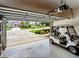 Garage with golf cart and view of backyard at 13217 Thoroughbred Dr, Dade City, FL 33525