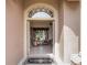 Front entry with arched window and view into spacious living room at 13217 Thoroughbred Dr, Dade City, FL 33525