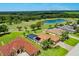 Aerial view of homes near a golf course and lake at 13217 Thoroughbred Dr, Dade City, FL 33525