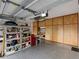 Garage with built-in shelving and cabinets at 13217 Thoroughbred Dr, Dade City, FL 33525