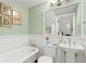 Classic bathroom with clawfoot tub, pedestal sink, and white fixtures at 2907 Fritzke Rd, Dover, FL 33527