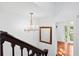 Elegant staircase with wooden railing and crystal chandelier at 2907 Fritzke Rd, Dover, FL 33527