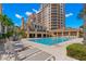 Resort-style pool with lounge chairs and building views at 521 Mandalay Ave # 405, Clearwater Beach, FL 33767