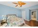 Bedroom with floral bedding, ceiling fan and ensuite bathroom access at 521 Mandalay Ave # 405, Clearwater Beach, FL 33767