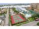 Community tennis courts and swimming pool with surrounding park-like landscaping at 521 Mandalay Ave # 405, Clearwater Beach, FL 33767