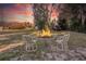 Backyard with fire pit and seating area under sunset at 1478 Alternate Keene Rd, Largo, FL 33771
