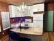 Modern kitchen with white cabinets and granite island at 1478 Alternate Keene Rd, Largo, FL 33771