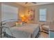 Bright bedroom with a queen bed and relaxing sitting area at 1478 Alternate Keene Rd, Largo, FL 33771