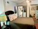 Cozy bedroom with a large bed and ensuite access to the kitchen at 1478 Alternate Keene Rd, Largo, FL 33771