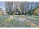 Large backyard with mature trees and a grassy area at 1478 Alternate Keene Rd, Largo, FL 33771