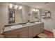 Double vanity bathroom with gray cabinets and updated fixtures at 1478 Alternate Keene Rd, Largo, FL 33771