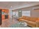 Living room with a tan couch and glass-top coffee table at 1478 Alternate Keene Rd, Largo, FL 33771