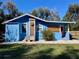 Blue house with a pink door and unique sun art at 1478 Alternate Keene Rd, Largo, FL 33771