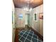 Hallway with wood floors and nautical rug at 1478 Alternate Keene Rd, Largo, FL 33771