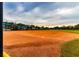 Community baseball field with dugout and seating at 15907 Cobble Mill Dr, Wimauma, FL 33598