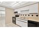 Small kitchen with white cabinets and black appliances at 3234 Jackson Dr, Holiday, FL 34691