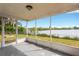 Bright screened porch overlooking peaceful waterfront view at 3234 Jackson Dr, Holiday, FL 34691