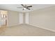 Spacious bedroom with ceiling fan and access to bathroom at 3234 Jackson Dr, Holiday, FL 34691