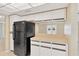 Kitchen features black refrigerator and white cabinets at 3234 Jackson Dr, Holiday, FL 34691