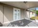 Screened porch with double doors leading to backyard at 3234 Jackson Dr, Holiday, FL 34691