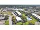 An aerial view shows the pool and well-maintained landscaping of this apartment complex at 1370 Heather Ridge Blvd # 107, Dunedin, FL 34698