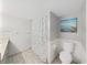 Bathroom featuring a shower with decorative seashell shower curtain at 1370 Heather Ridge Blvd # 107, Dunedin, FL 34698