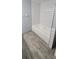 Bathroom with a white subway tile shower, a deep soaking tub, and wood-look floors at 1370 Heather Ridge Blvd # 107, Dunedin, FL 34698