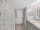Bathroom featuring a granite countertop vanity, seashell curtain, and tiled floors at 1370 Heather Ridge Blvd # 107, Dunedin, FL 34698