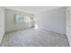 Sunlit bedroom with wood-look tile flooring and a large window providing ample natural light at 1370 Heather Ridge Blvd # 107, Dunedin, FL 34698