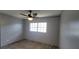 Cozy bedroom with wood-look flooring, neutral paint, and a ceiling fan at 1370 Heather Ridge Blvd # 107, Dunedin, FL 34698