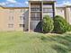 Exterior of building features screened in balconies and well-maintained landscaping at 1370 Heather Ridge Blvd # 107, Dunedin, FL 34698