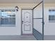 Condo unit featuring a white front door with sidelight windows at 1370 Heather Ridge Blvd # 107, Dunedin, FL 34698
