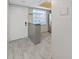 Kitchen with breakfast bar and stainless steel refrigerator at 1370 Heather Ridge Blvd # 107, Dunedin, FL 34698