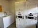 Bright laundry room featuring newer washers and dryers for resident's use and convenience at 1370 Heather Ridge Blvd # 107, Dunedin, FL 34698