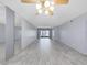 Bright living room features tile flooring, a ceiling fan, and sliding glass doors to the outdoors at 1370 Heather Ridge Blvd # 107, Dunedin, FL 34698