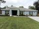 Charming single-story home with a well-manicured lawn and lovely landscaping at 15207 Taralane Ave, Brooksville, FL 34604