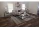 Living room featuring a gray sofa and glass-top coffee table at 1812 N Barnes St, Plant City, FL 33563