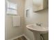 Simple bathroom with a pedestal sink and linen storage at 1812 N Barnes St, Plant City, FL 33563