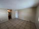 Bedroom with tile flooring, a door to the bathroom and a closet at 9209 Dalwood Ct, Tampa, FL 33615