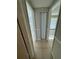 Clean hallway with tile floors and a folding door at 9209 Dalwood Ct, Tampa, FL 33615