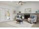 Bright living room features a fireplace, large windows, and comfortable seating at 1921 Blue Heron Way, Palm Harbor, FL 34683