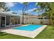 Inviting backyard oasis with a sparkling pool at 1921 Blue Heron Way, Palm Harbor, FL 34683