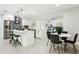 Modern kitchen with white cabinets, island, and dining area at 1921 Blue Heron Way, Palm Harbor, FL 34683