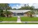 Charming single-story home with stone facade and landscaped yard at 1921 Blue Heron Way, Palm Harbor, FL 34683