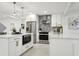 Modern kitchen with white cabinets, stainless steel appliances and quartz countertops at 1921 Blue Heron Way, Palm Harbor, FL 34683