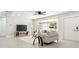 Bright living room featuring a comfy sofa and large windows at 1921 Blue Heron Way, Palm Harbor, FL 34683